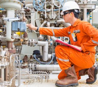 A mechanical engineer, who is protected by engineering insurance, running a maintenance check