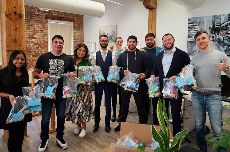The KASE Insurance team posing with their Kits for a Cause