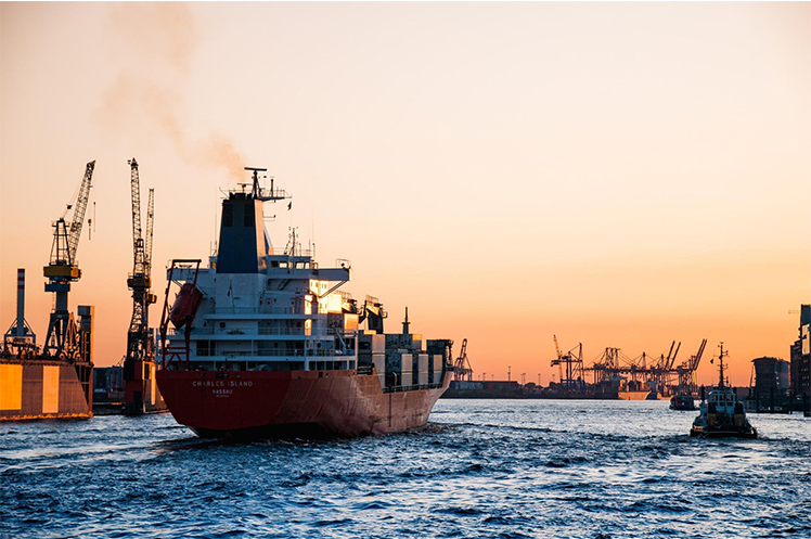 A container ship sailing into the sunset