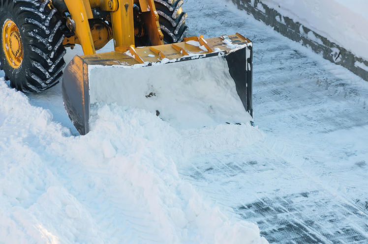 Close-up of a tractor clearing snow away