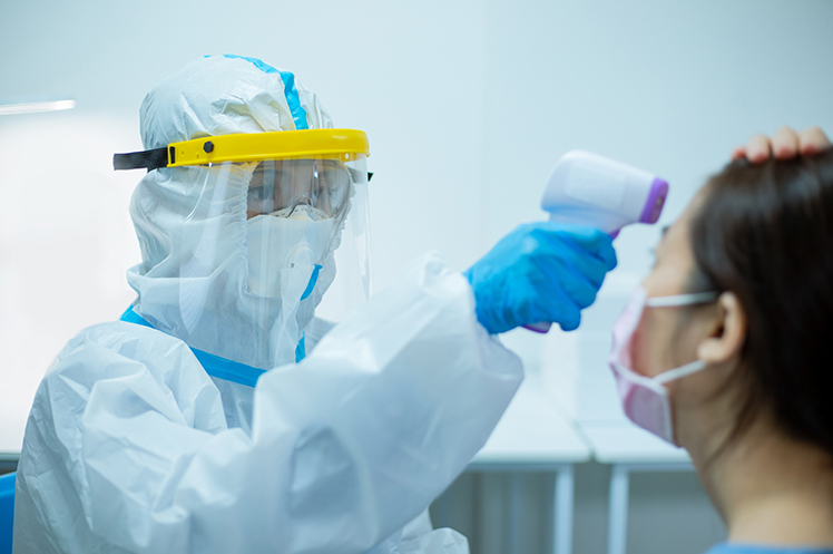 A health worker wearing PPE kit