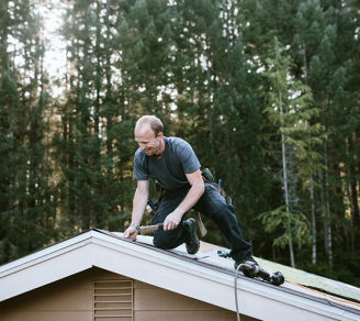 A roofing contractor installing tiles on a rooftop