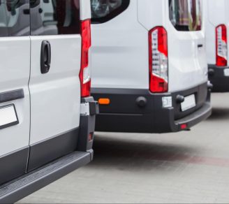 The back part of a parked fleet of commercial vehicles