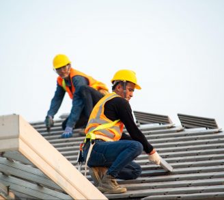 Two roofing contractors at work