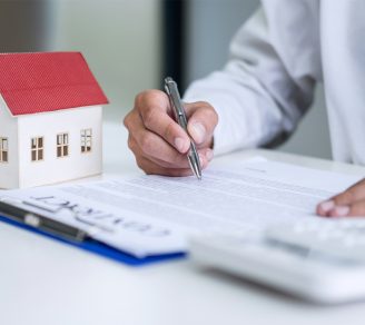A landlord signing an insurance contract for multiple properties