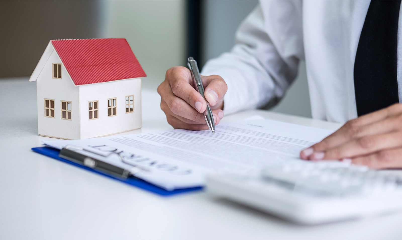A landlord signing an insurance contract for multiple properties