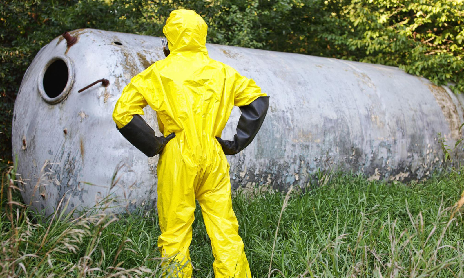 A technician examining a newly removed storage tank which could be the source of pollution liability claims