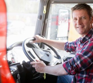 A transport driver smiling behind the wheel