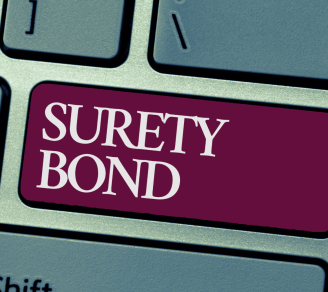 The words “surety bond” is in bold text on a keyboard.