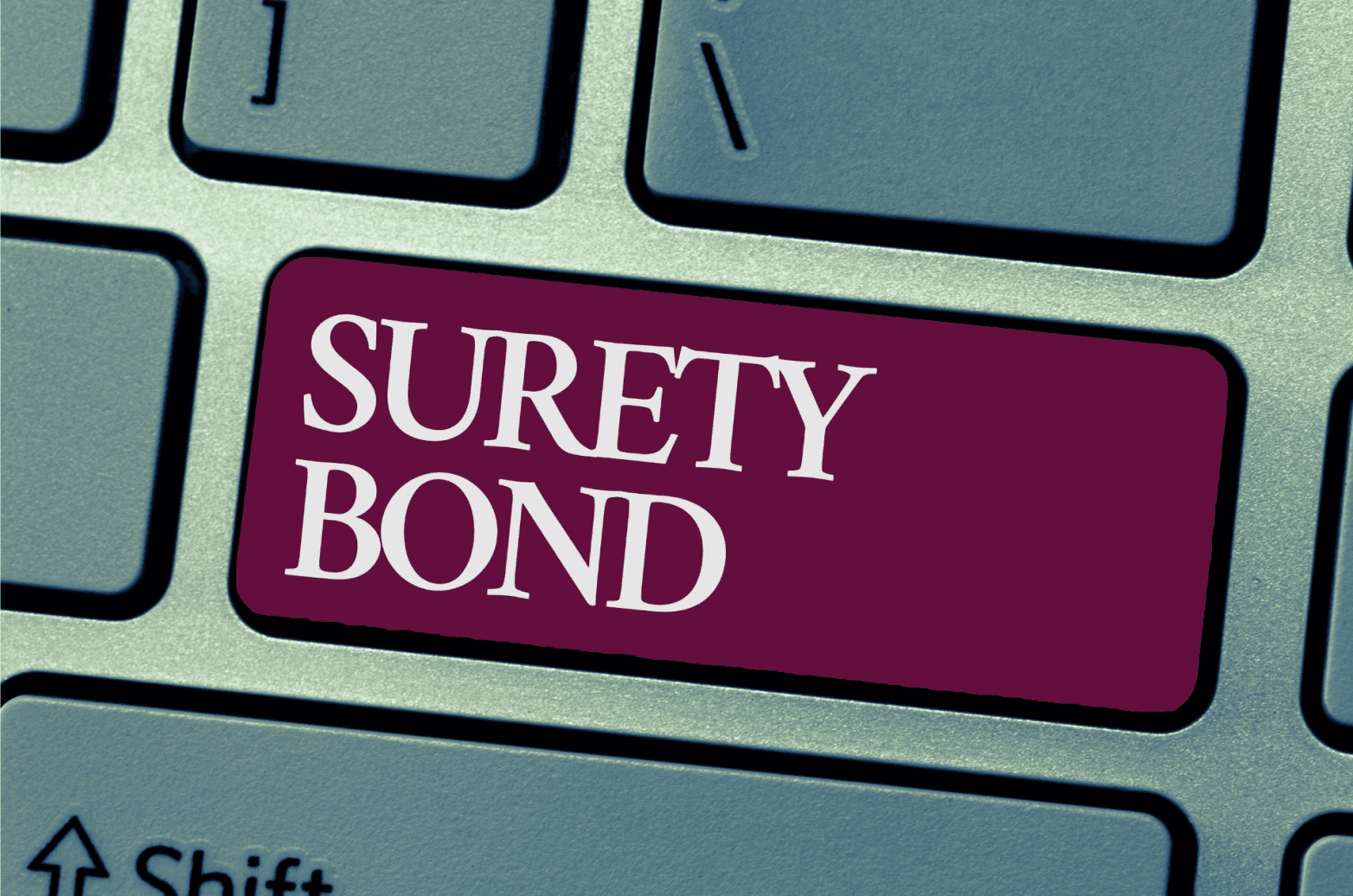 The words “surety bond” is in bold text on a keyboard.