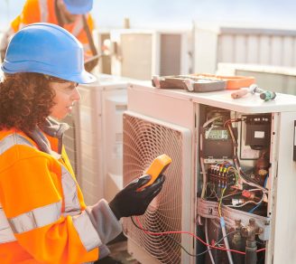 An electrical contractor working on an HVAC unit’s wirings.