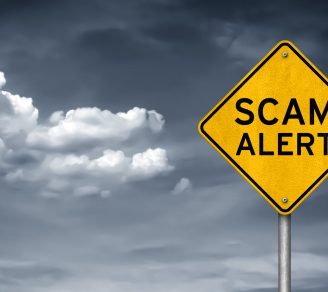 A road sign with the words “scam alert” written on it.