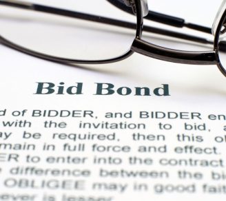 A close-up of a bid bond contract and a pair of glasses