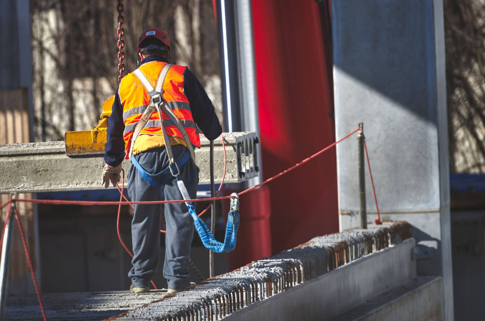 A contractor with a safety harness working from heights
