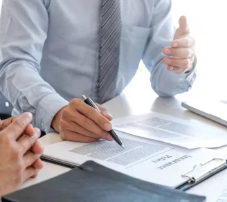 An insurance broker explaining an insurance policy’s terms to a client