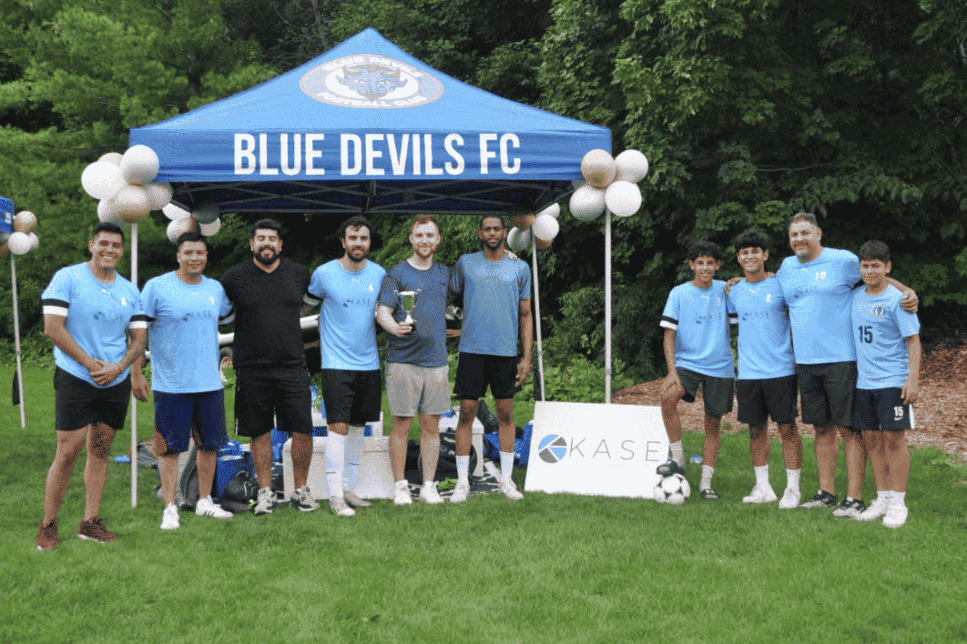 The KASE Insurance team with members of Blue Devils FC