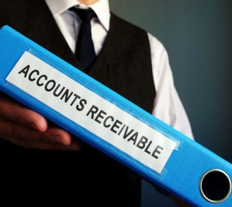 Person holding an AR collection binder labelled “Accounts receivable”