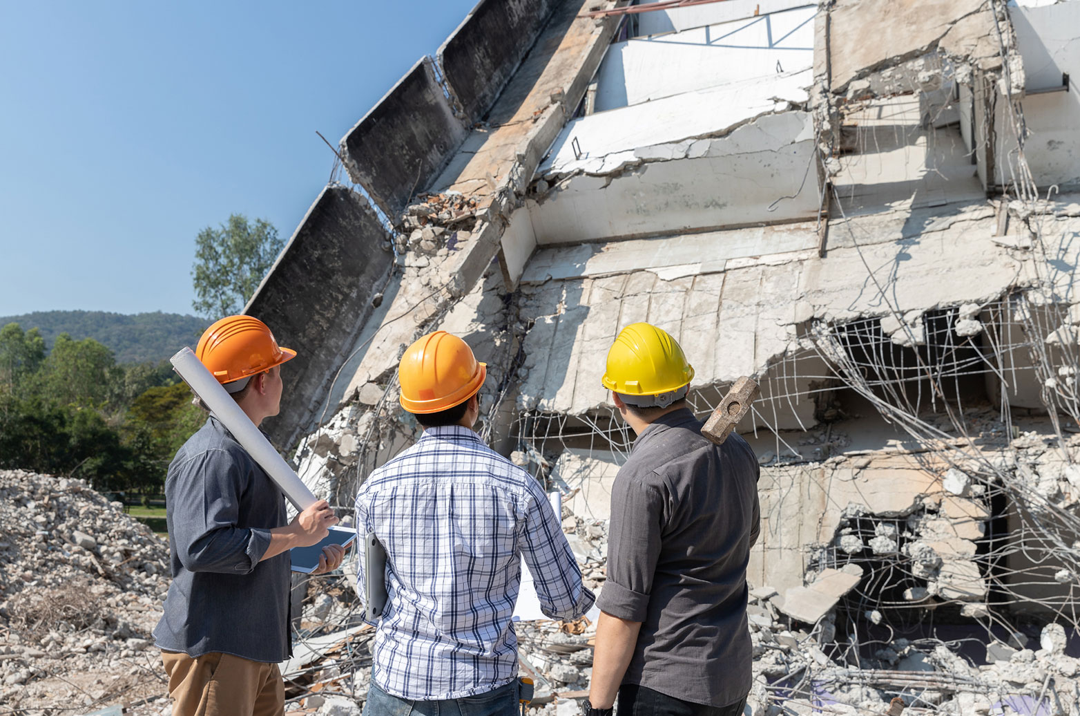 ODCA members wearing hard hats on a demolition site outdoors