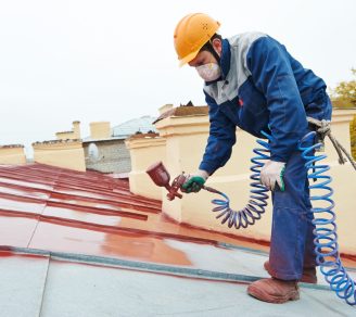 Ontario Painting Contractors Association member painting roof with airbrush