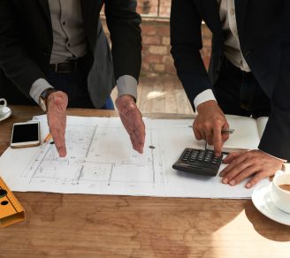 Project managers discussing the potential cost overrun of the project