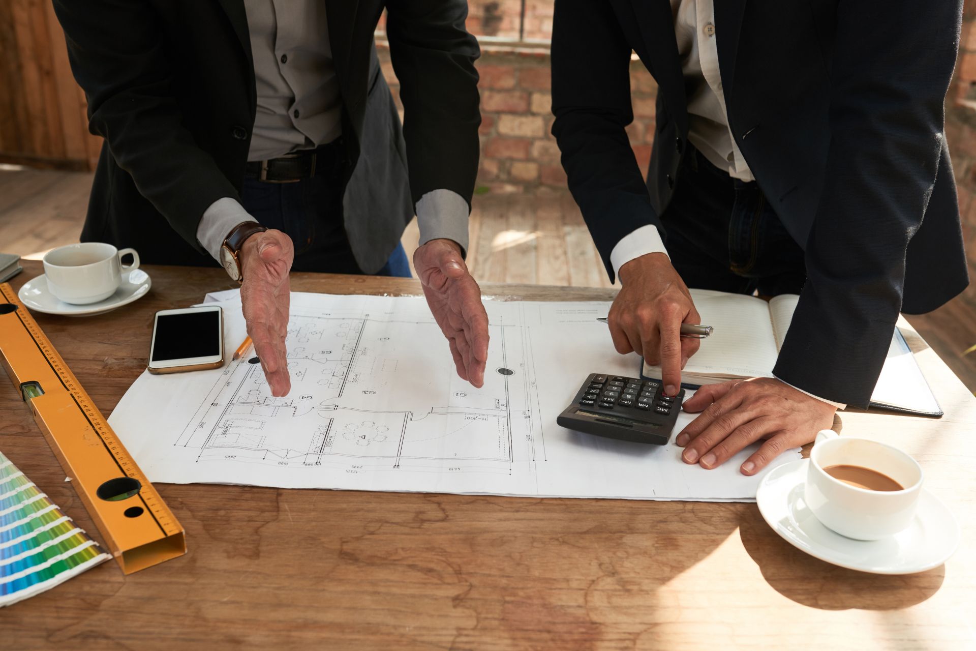 Project managers discussing the potential cost overrun of the project