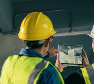 Construction workers using AI in construction to inspect building