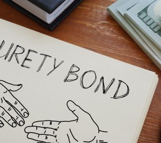 Surety bond written in a notebook, a sketch of two hands reaching for a handshake