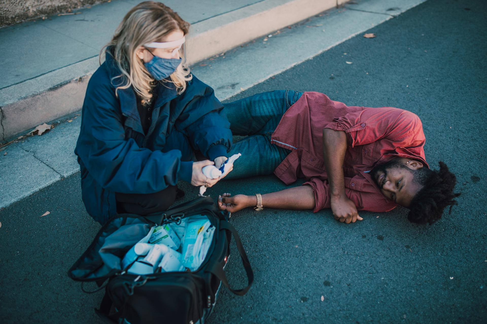 A paramedic helping an injured person on the floor