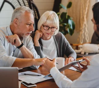 An older couple reviews an insurance document for their new apartment.